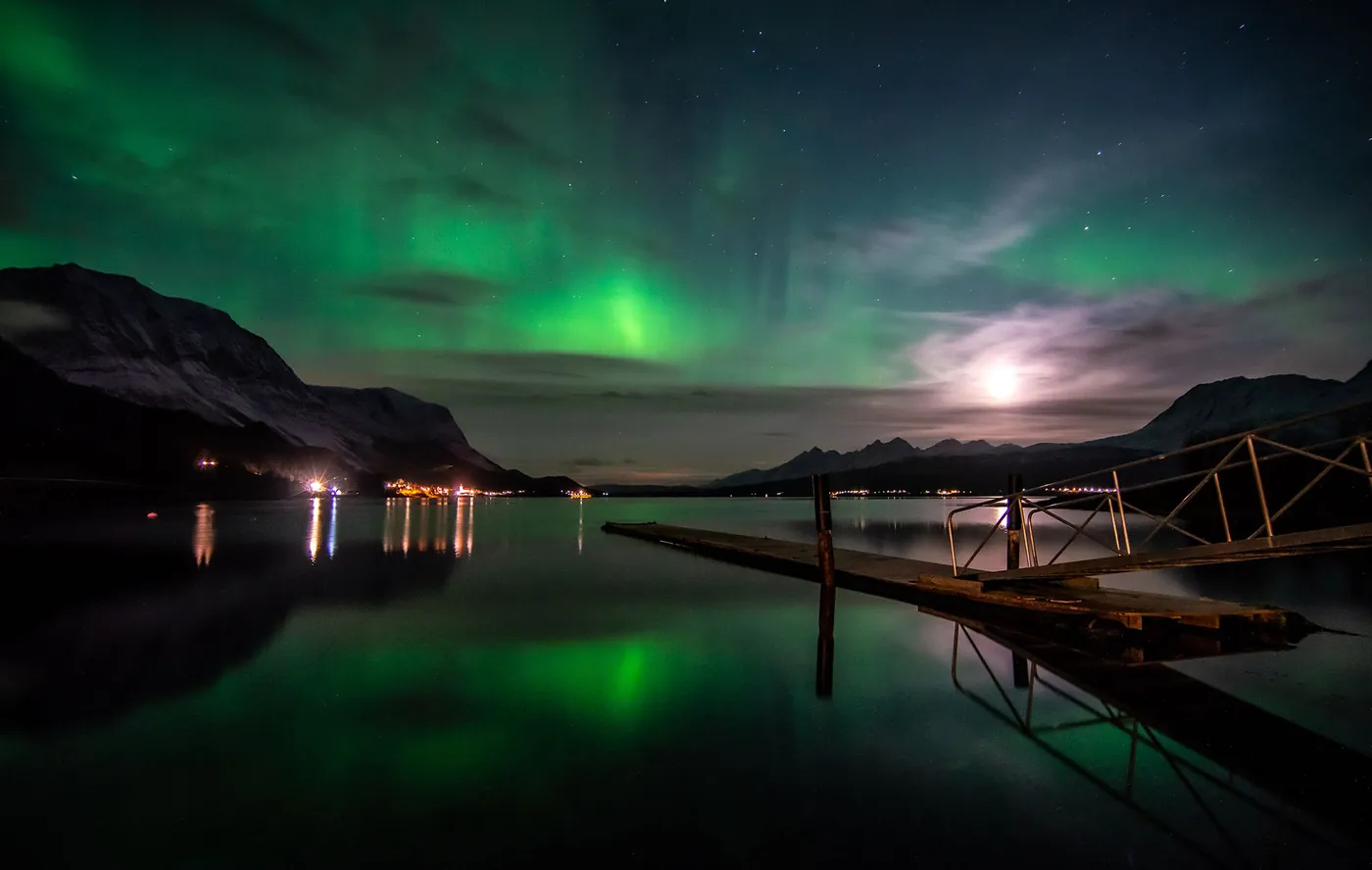 Northern lights and moon above the jetty